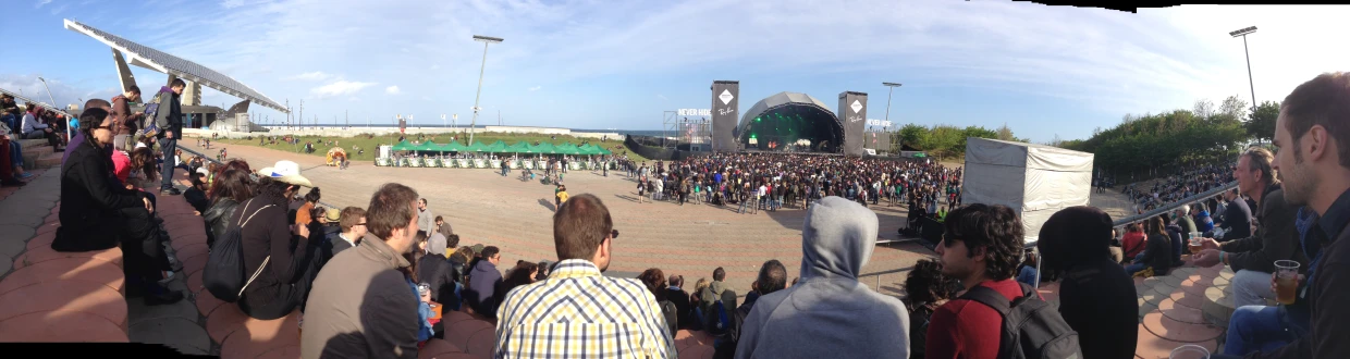 a group of people standing around a crowd watching