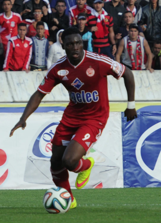 a man on a field kicking a soccer ball