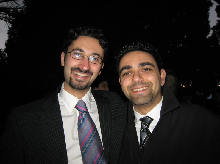 two men posing for a picture at a party