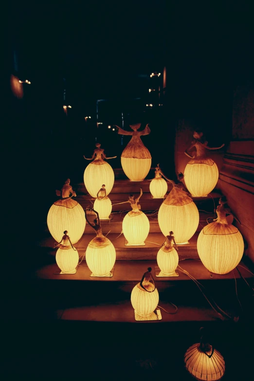 a bunch of yellow lit up lanterns in the dark