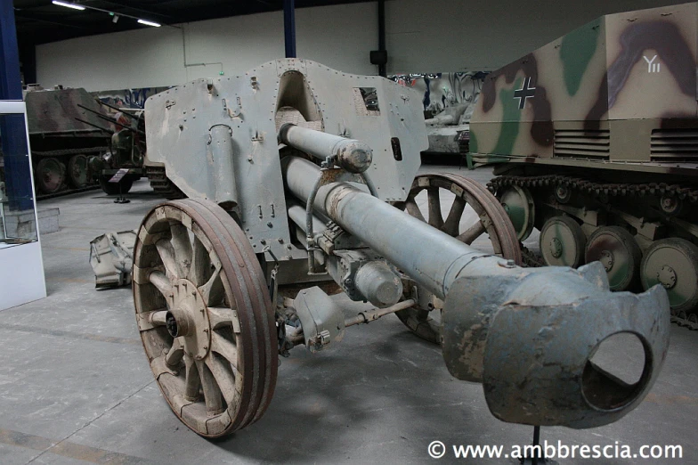 a large rusted old artillery is on display