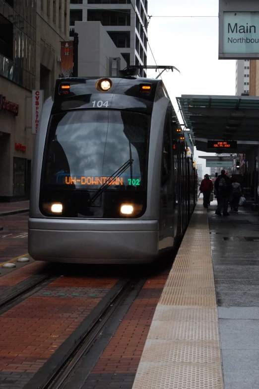 a modern commuter train at an outdoor station