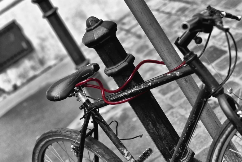 a bicycle locked on the pole of a pedestrian gate