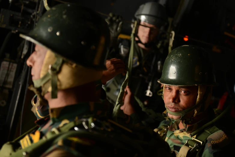 two military men are posing for the camera