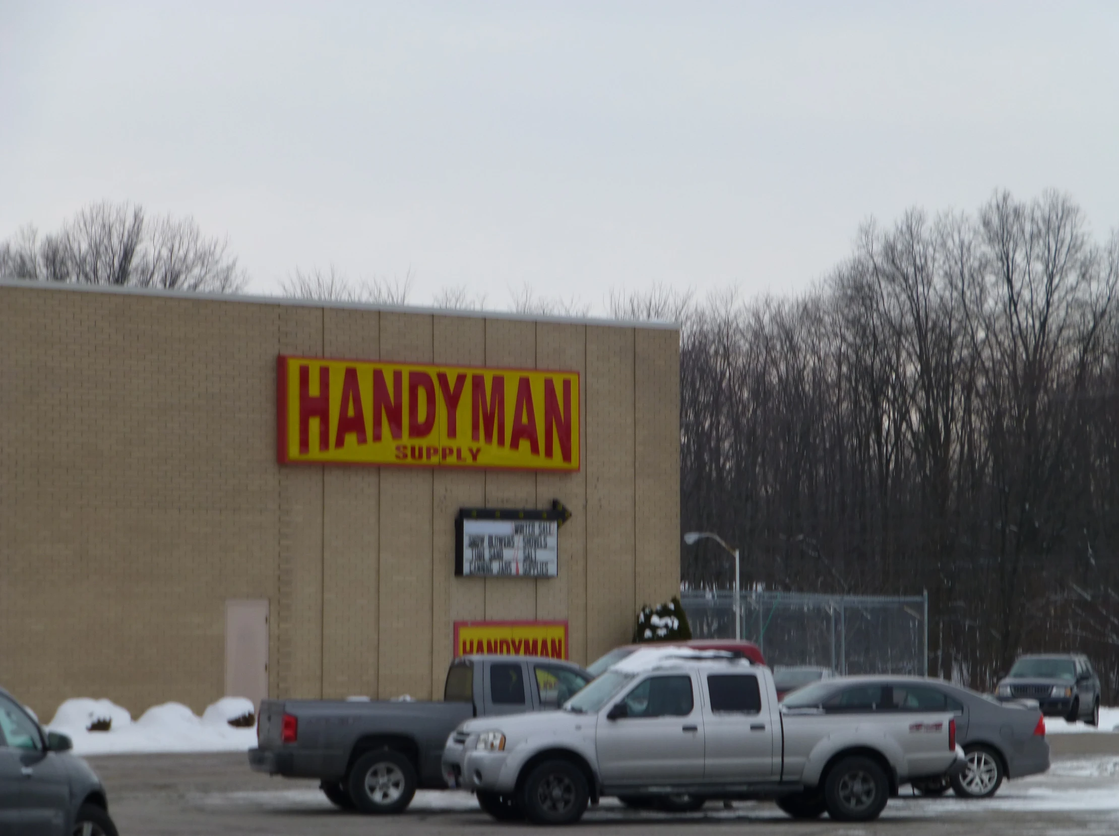 many cars are parked outside of a man store