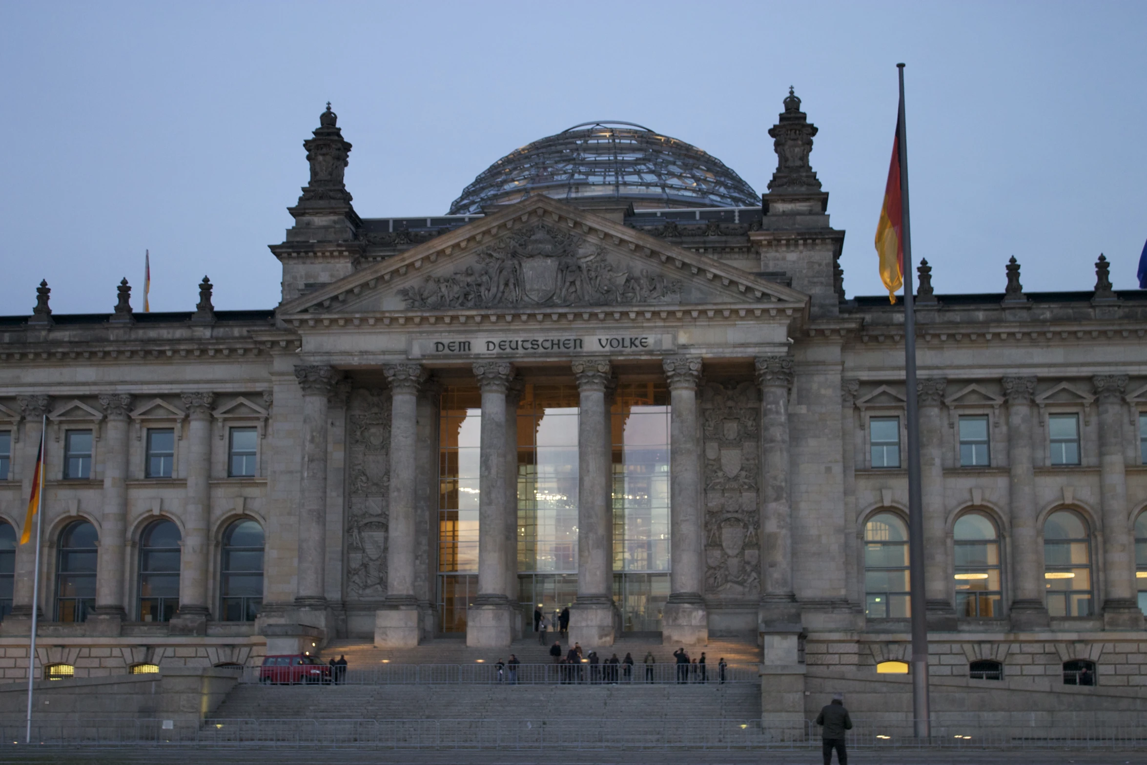 a large building with columns and two towers