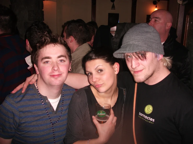 three men are posing for a picture while smiling