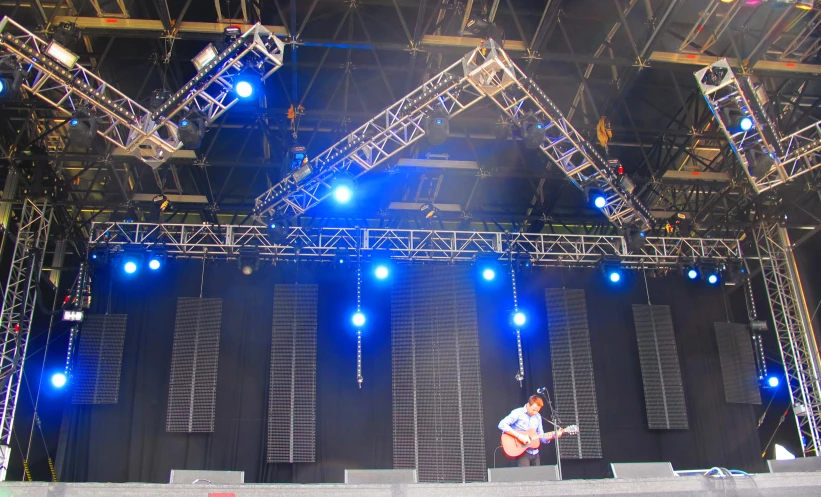 a large stage with lights on and a guitar on the stage