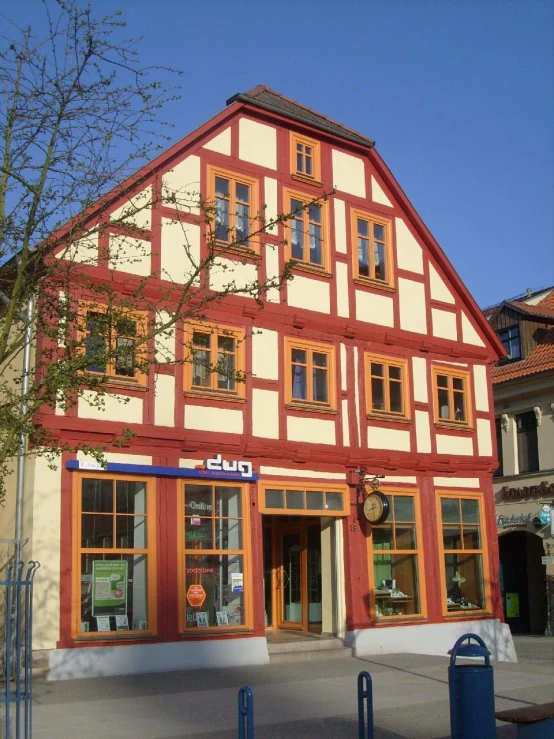 a large building that has some red and white windows