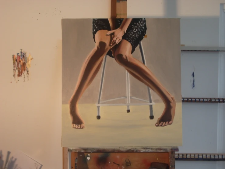 a painting is shown with a woman's legs on a chair