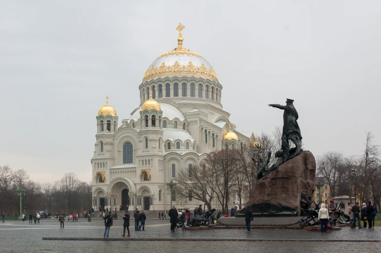 a view of a very large building with some statues around it