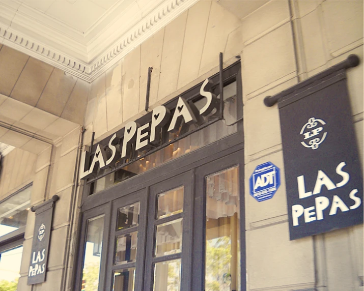 the entrance of a restaurant with signs on the outside