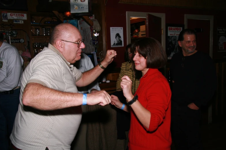 a man and woman are dancing together in a bar