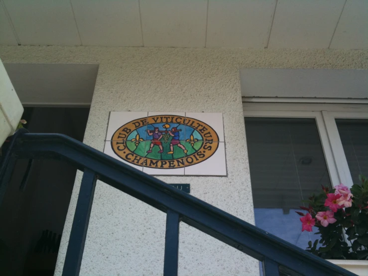 a blue banister is leading down to a door with a sign on it