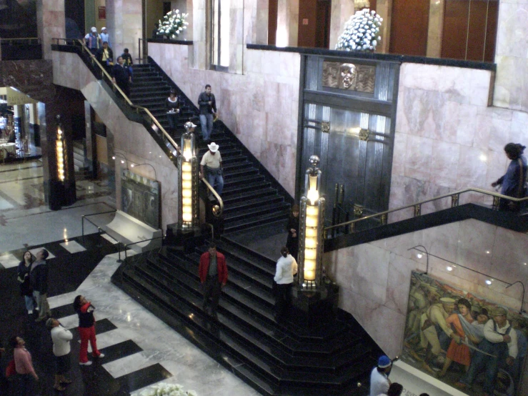 an empty building filled with escalators and people