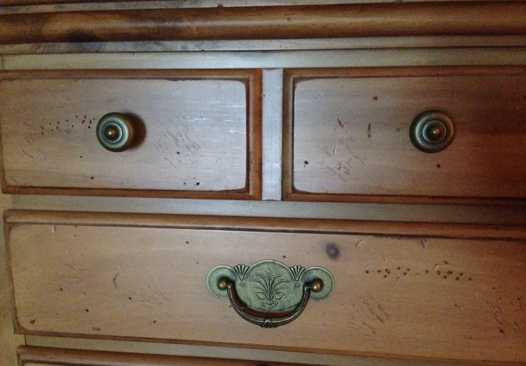 some drawers with a metal handle on them