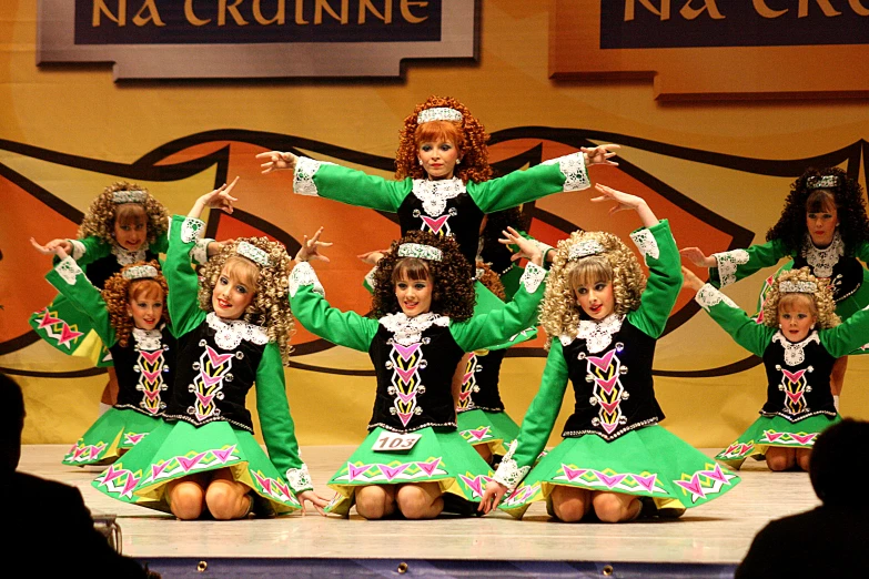 a group of children sitting on top of a stage