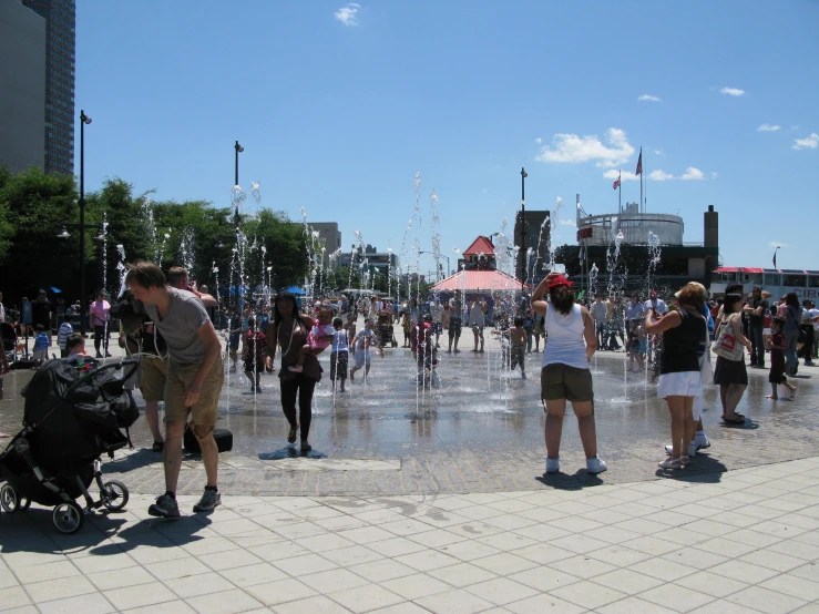 a group of people are playing with a fountain