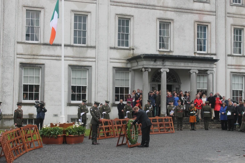 some people near a huge white building and several flags