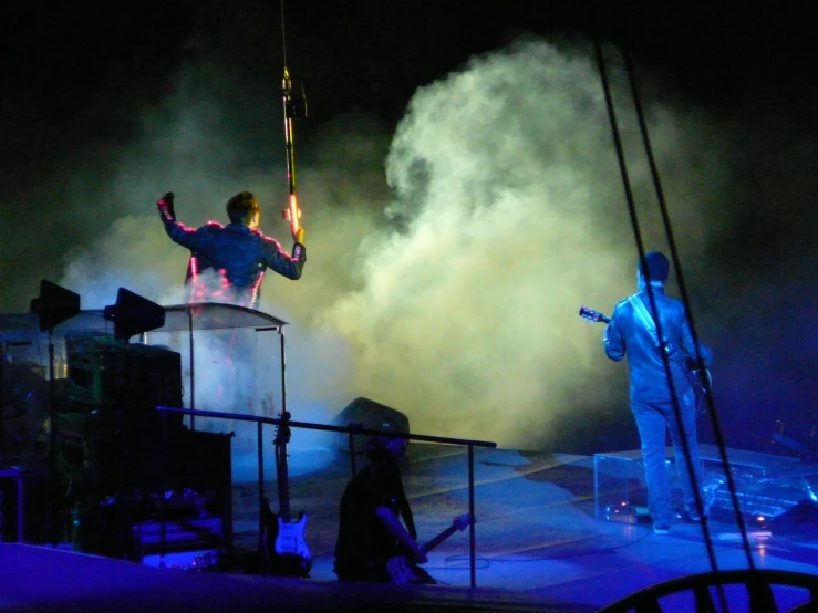 two people in costumes are performing on stage