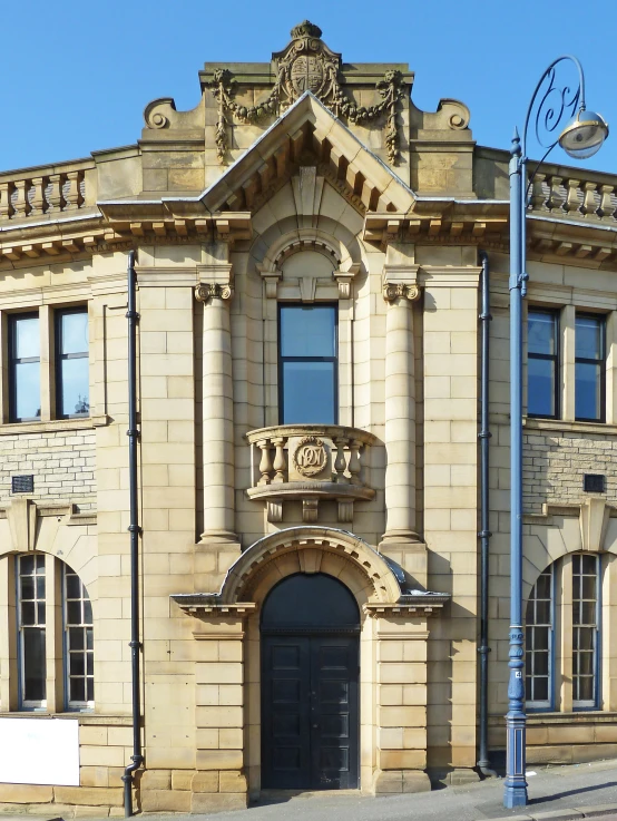 a large brown building with an arch doorway