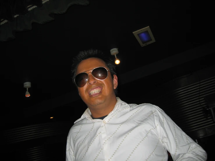 a man in sunglasses posing for the camera