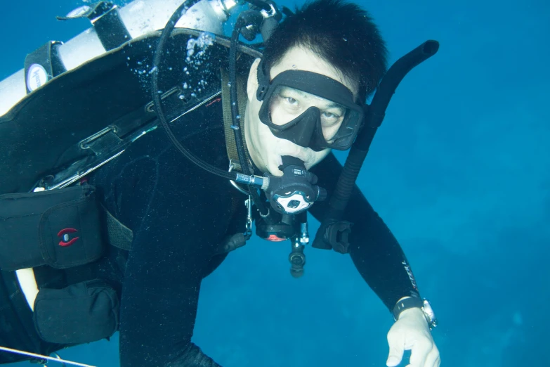 a man wearing a diving mask and a camera on his hands