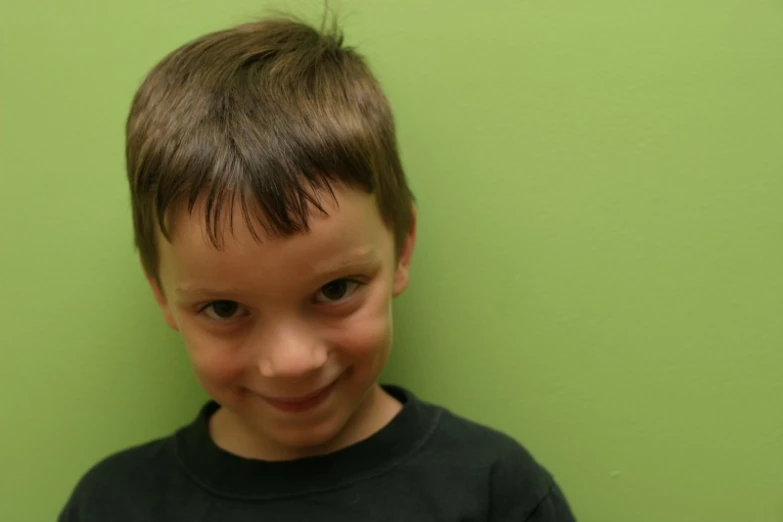  smiling in green background with dark hair