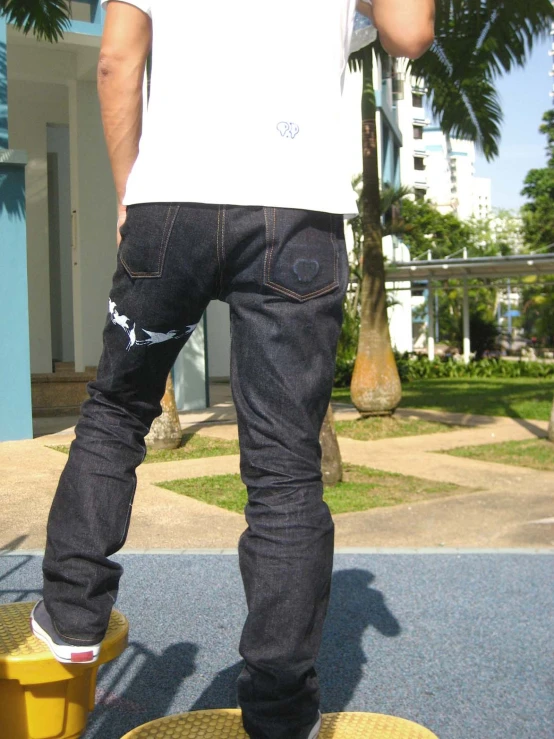 a man is standing on a skateboard in front of some buildings