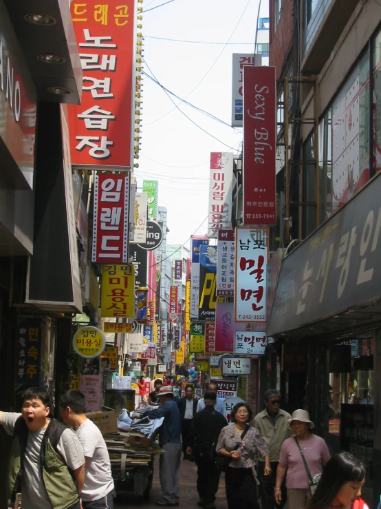 people walk down an alley in the city