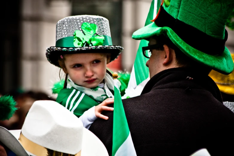 there is a  wearing a green hat and a man