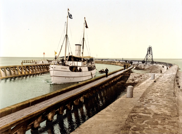 a boat docked near the sea next to a pier