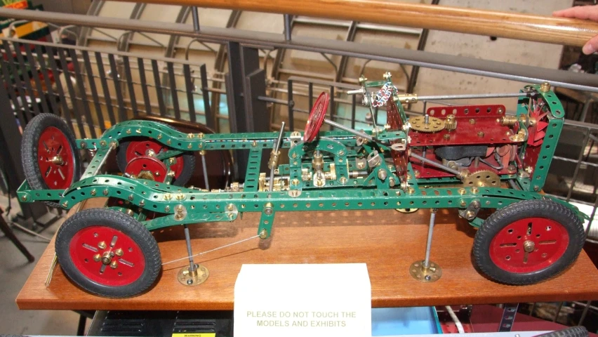 an assembled vehicle in wooden case sitting on display