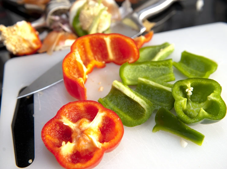 the peppers have been sliced in half on the  board