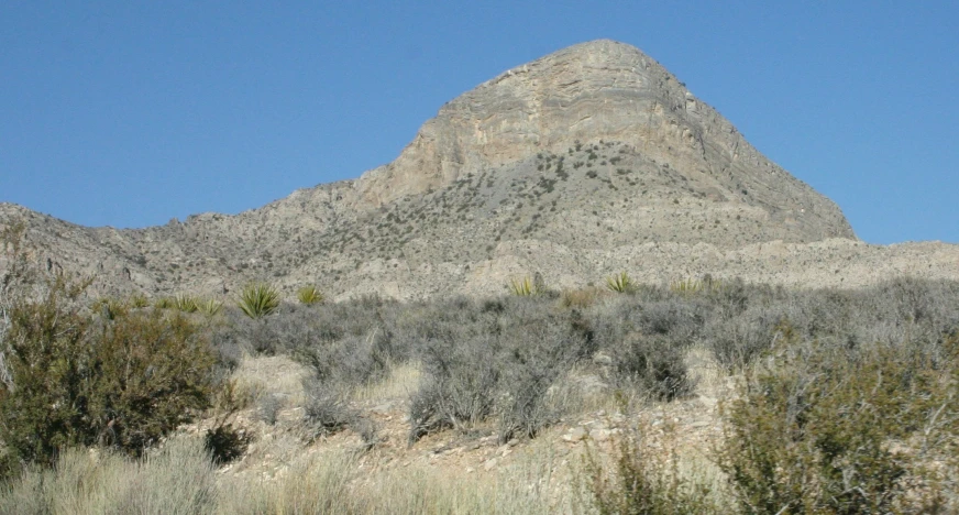 there is a very tall, rocky mountain in the middle of nowhere