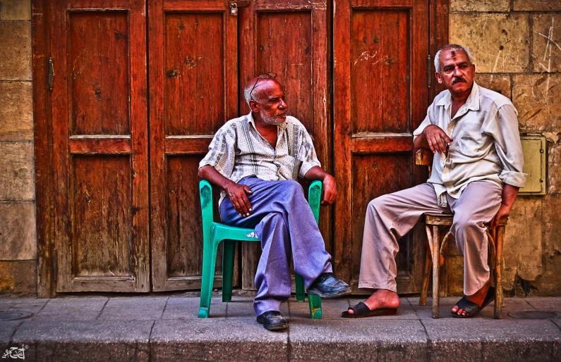 a couple of people sitting in chairs outside