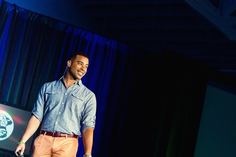 a man on stage performing for an audience