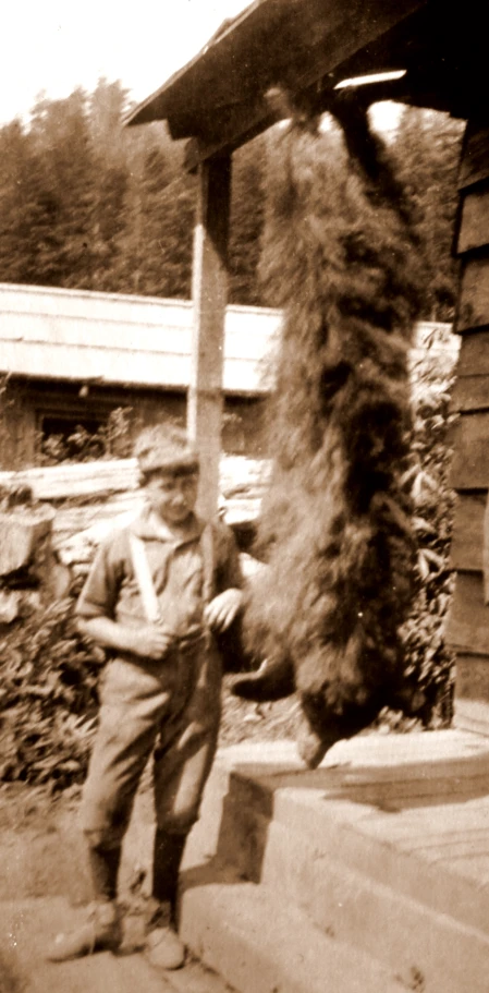 a man stands near a building, posing for the camera