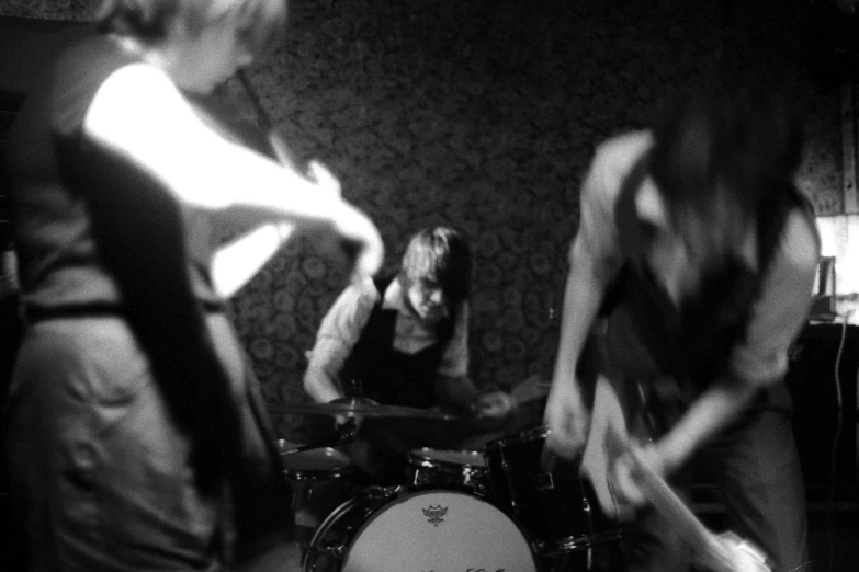 two women are playing drums on a stage