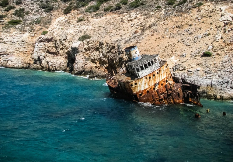a rusty and dilapidated boat floats in the water