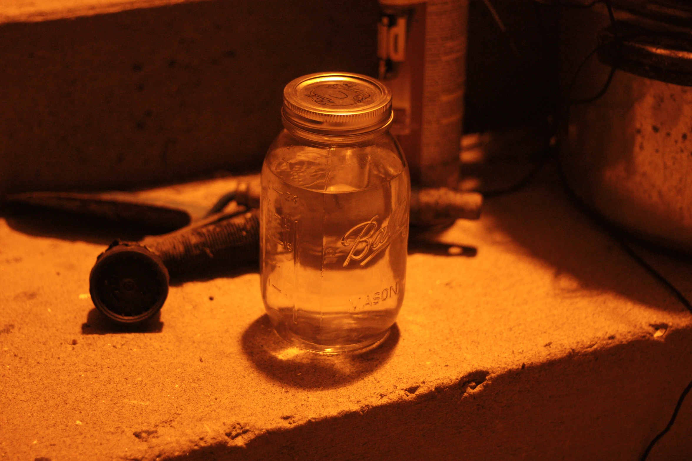 a bottle and scissors sitting on top of a table