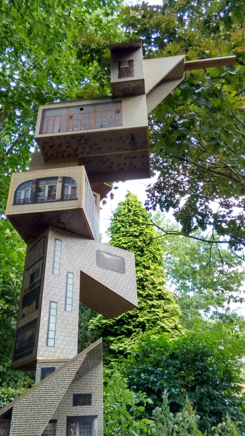 an artistic building stands in the trees