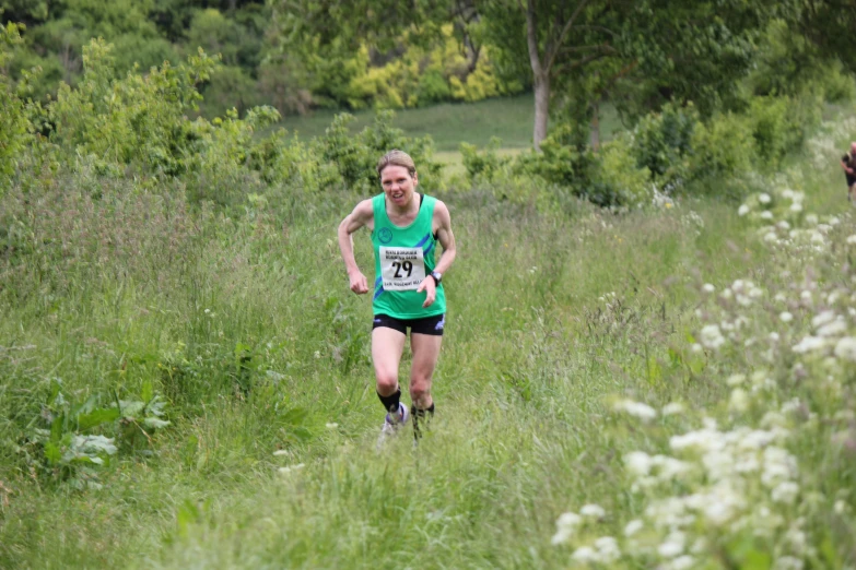 this man is running through the grass in a green shirt