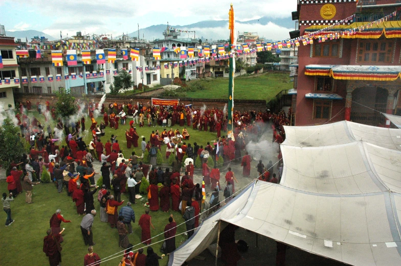 crowds of people walking around with tents and flags