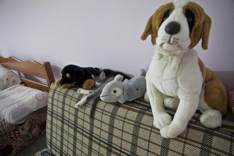 there is a stuffed animal on the bed with other toy animals