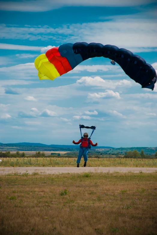 a man standing on top of a field flying a kite