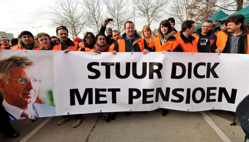 a group of people holding up signs outside