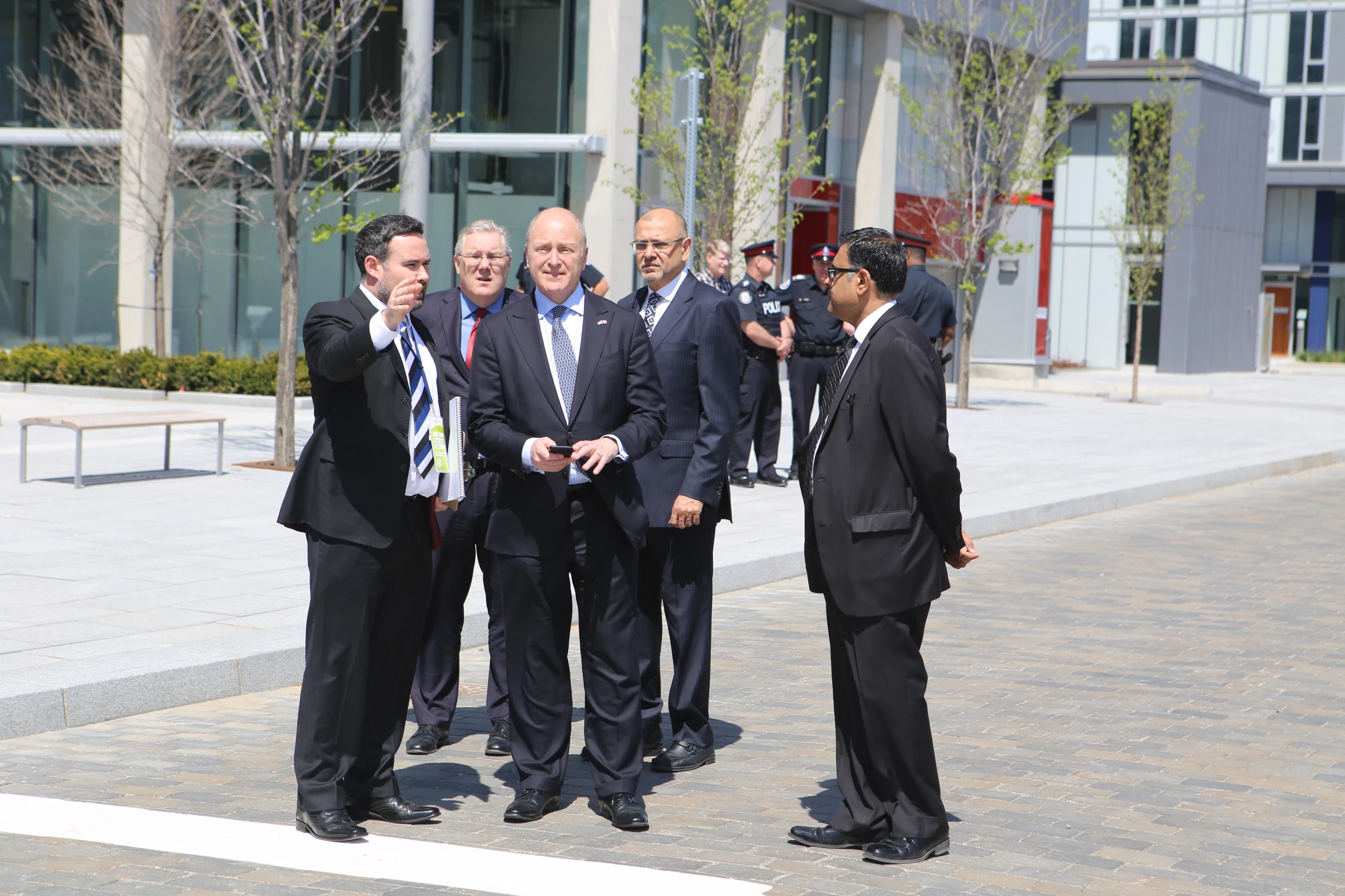 men in business attire standing and holding soing