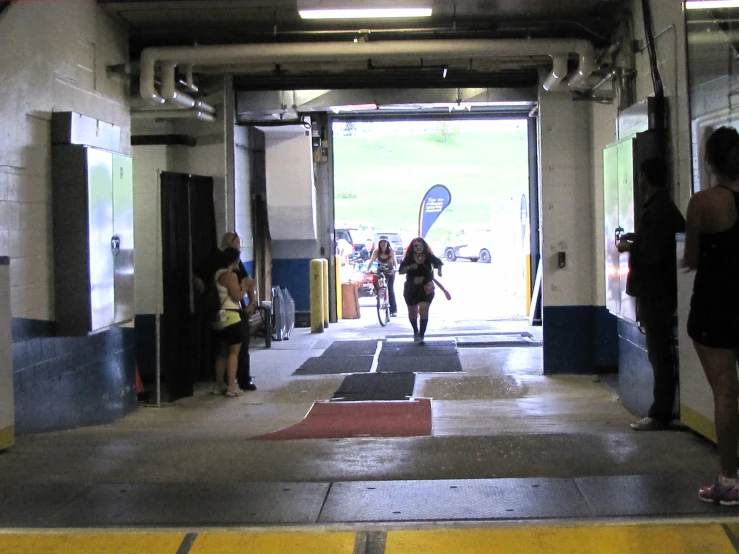 three women walk in and out of a building together