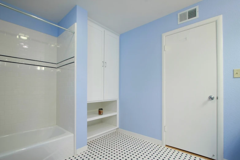 a blue and white bathroom with a white cupboard